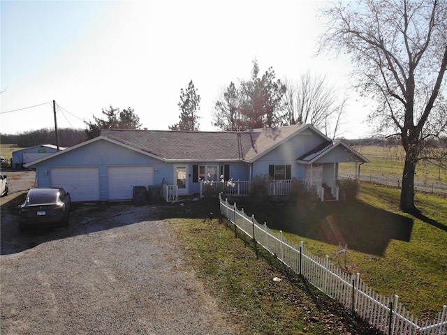 ranch-style house featuring driveway, a garage, and fence