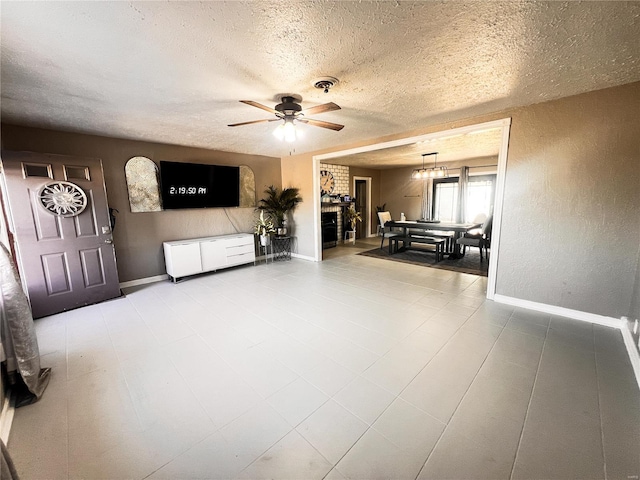 living area featuring visible vents, a textured ceiling, and baseboards