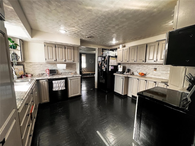 kitchen featuring black appliances, tasteful backsplash, and dark wood-style flooring