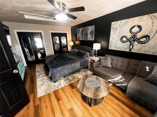 bedroom featuring ceiling fan, a textured ceiling, and wood finished floors