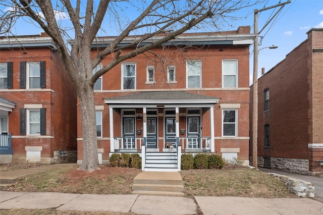 multi unit property with brick siding and covered porch