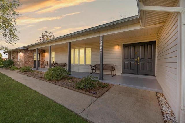 exterior entry at dusk with a porch