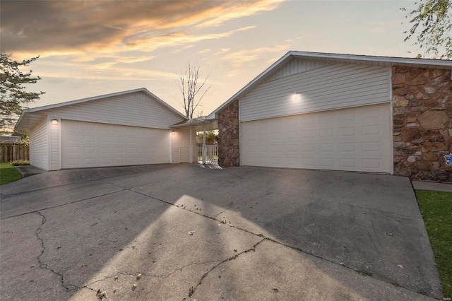 view of front of house with a garage and an outbuilding