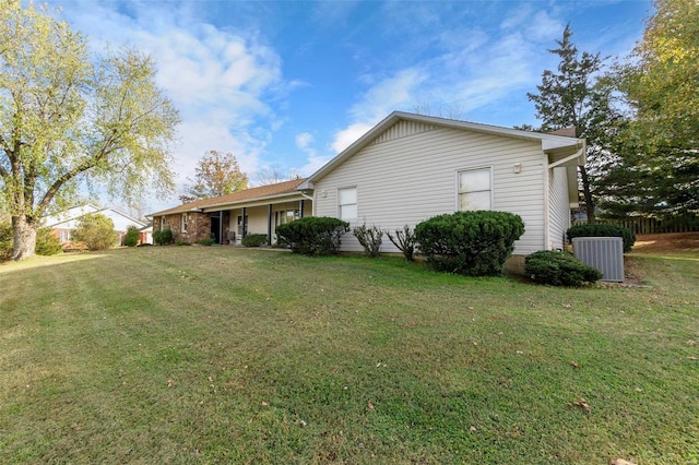 view of property exterior featuring a lawn and cooling unit