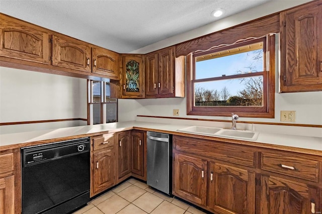 kitchen with dishwasher, light tile patterned flooring, and sink