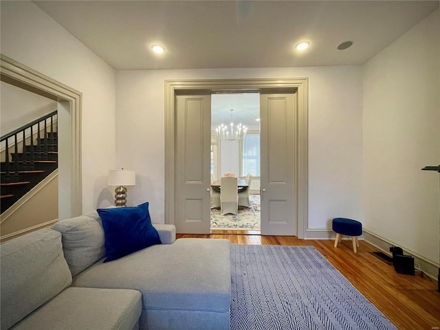 living room featuring hardwood / wood-style flooring and a chandelier