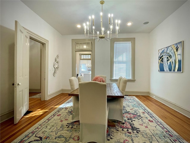 dining room featuring wood-type flooring and a notable chandelier