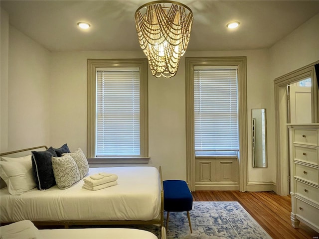 bedroom featuring light hardwood / wood-style floors and a chandelier