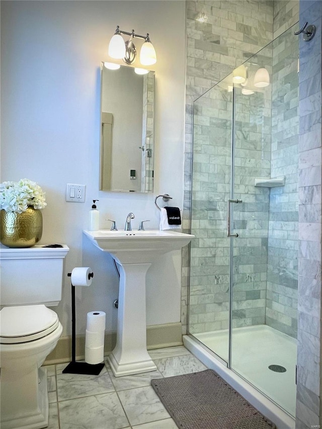 bathroom featuring toilet and walk in shower