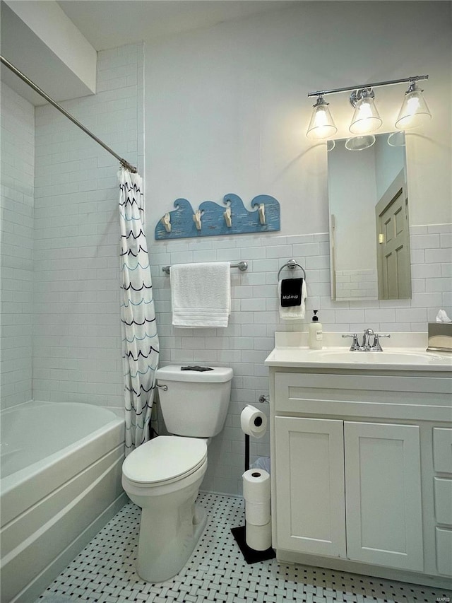 full bathroom with toilet, vanity, shower / tub combo with curtain, and tile walls