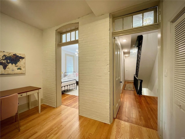 hallway with light hardwood / wood-style floors