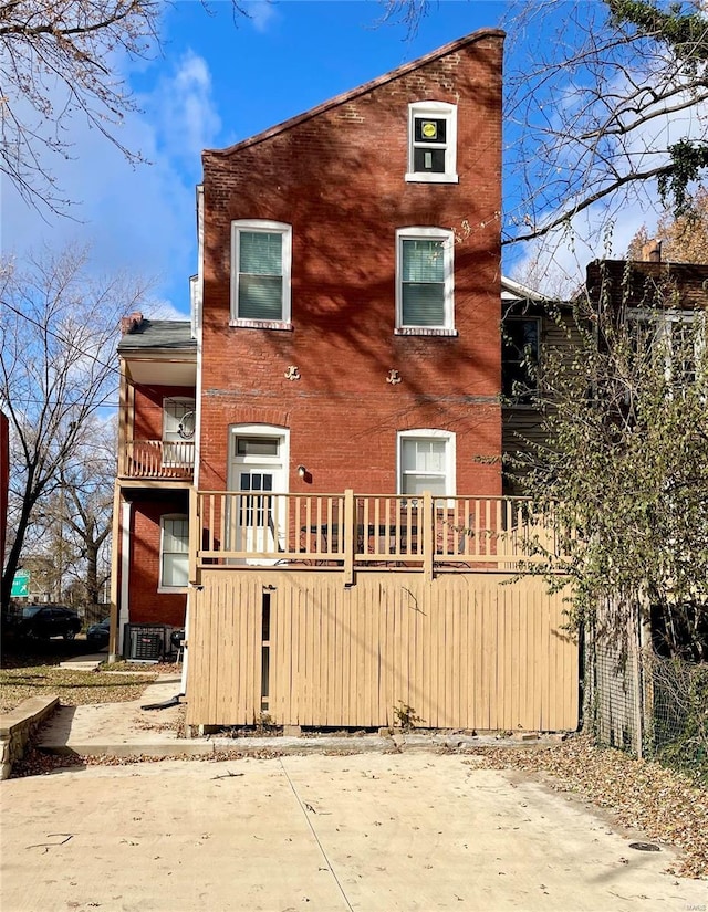 rear view of property featuring central AC unit