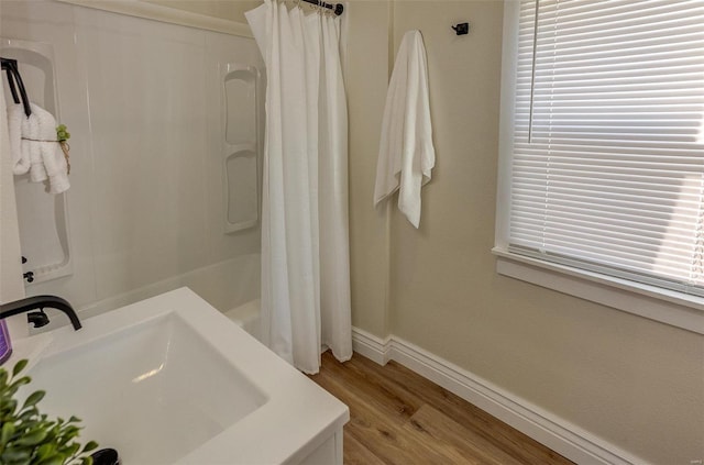 bathroom featuring a wealth of natural light, sink, and wood-type flooring