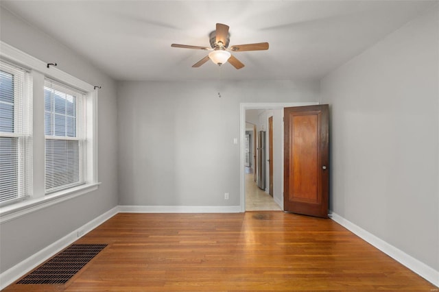 unfurnished room with ceiling fan and light hardwood / wood-style floors