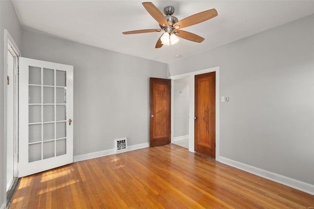 unfurnished room with hardwood / wood-style floors and ceiling fan