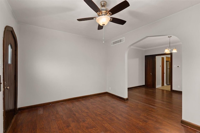 unfurnished room with crown molding, dark wood-type flooring, and ceiling fan with notable chandelier