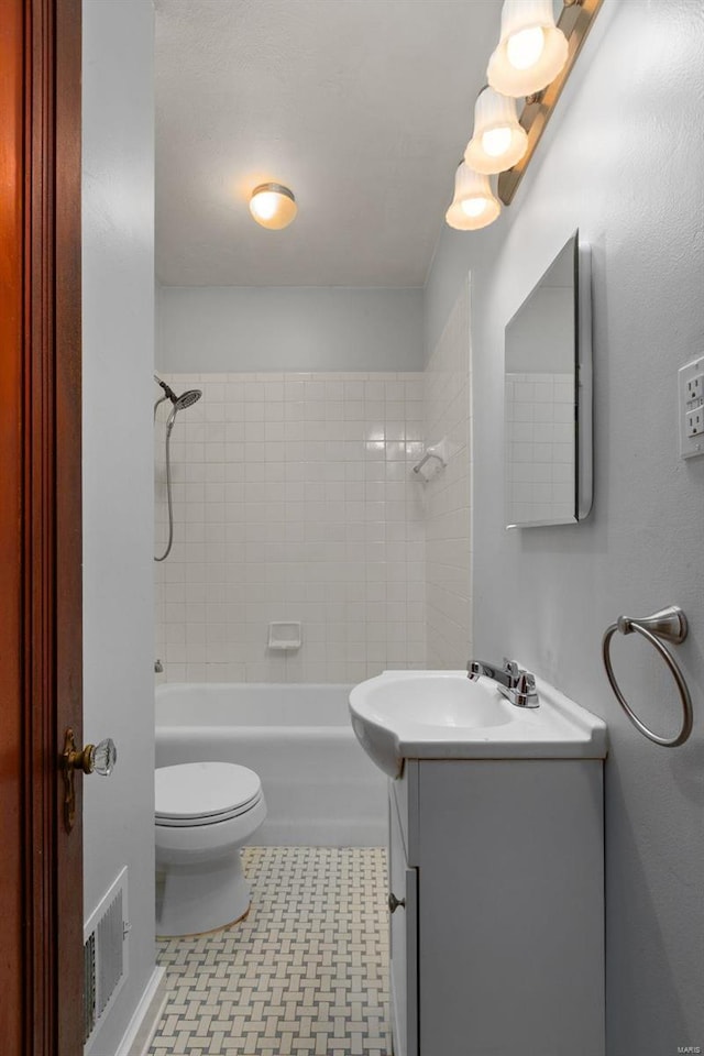 full bathroom featuring vanity, toilet, and tiled shower / bath