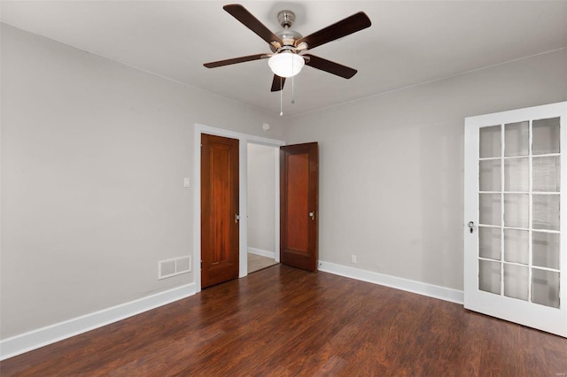 spare room with ceiling fan and dark wood-type flooring