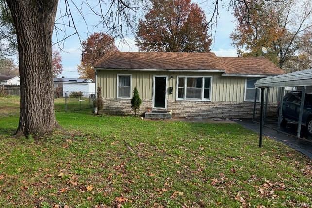 ranch-style house with a carport and a front yard