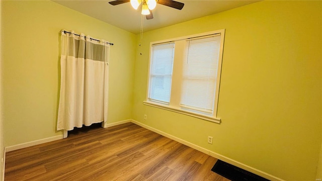 unfurnished room featuring hardwood / wood-style flooring and ceiling fan