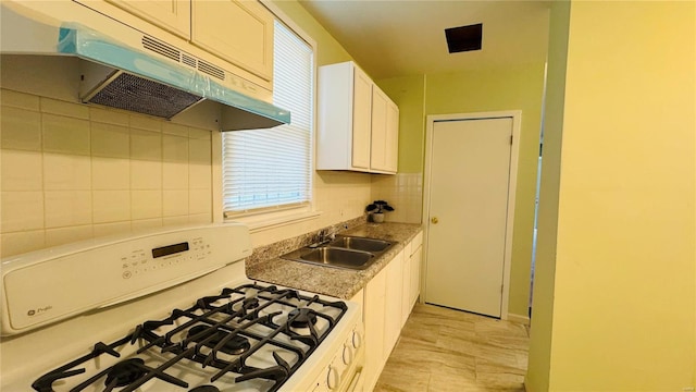 kitchen featuring tasteful backsplash, sink, white cabinets, white range with gas cooktop, and light stone countertops