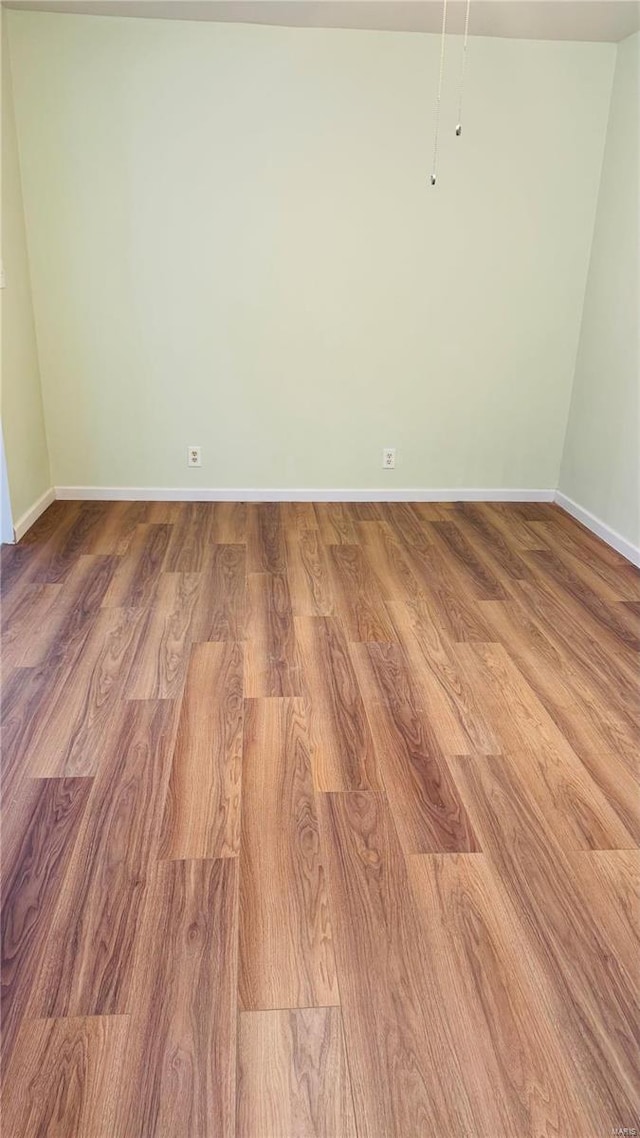 unfurnished room with hardwood / wood-style floors