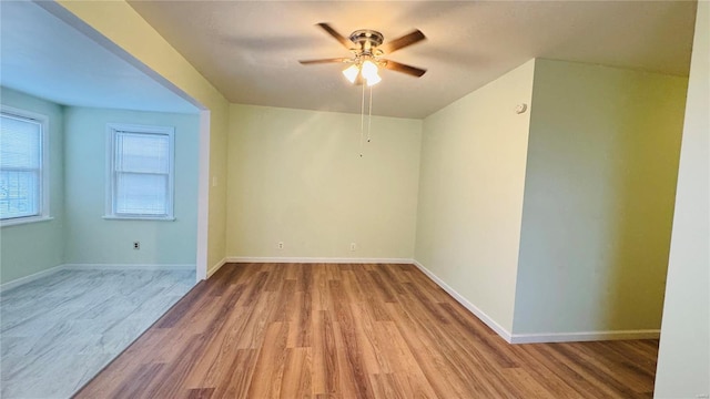 spare room with ceiling fan and light hardwood / wood-style flooring