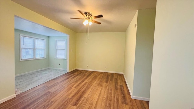 spare room featuring ceiling fan and light hardwood / wood-style flooring