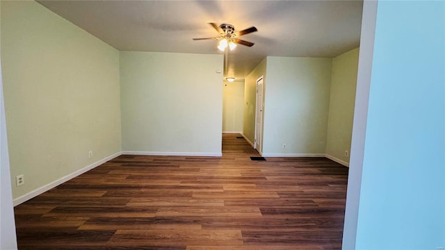 empty room featuring dark wood-type flooring and ceiling fan