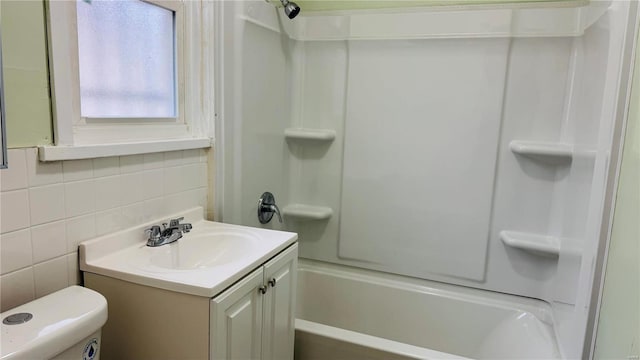 full bathroom featuring toilet, tasteful backsplash, tile walls, shower / bathtub combination, and vanity