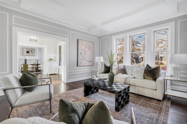 living room with beamed ceiling, dark wood-type flooring, coffered ceiling, and an inviting chandelier