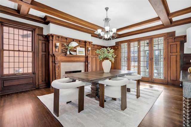 dining area featuring ornamental molding, coffered ceiling, dark wood-type flooring, an inviting chandelier, and beamed ceiling