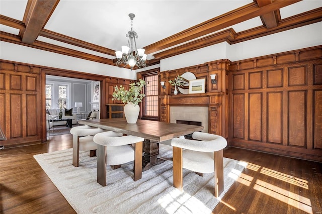 dining area featuring a chandelier, dark hardwood / wood-style floors, crown molding, and coffered ceiling