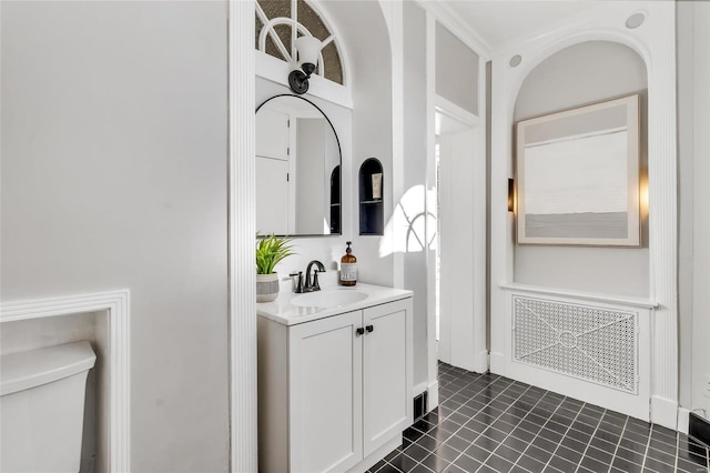 bathroom featuring tile patterned flooring, vanity, and toilet