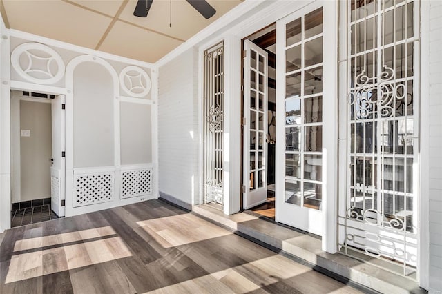 interior space featuring hardwood / wood-style flooring, ceiling fan, and crown molding