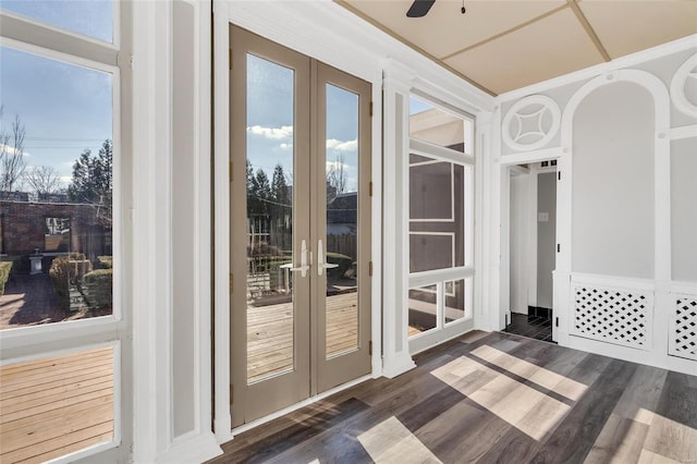 doorway to outside featuring french doors, ceiling fan, and dark wood-type flooring