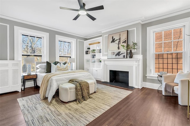 bedroom featuring ceiling fan, dark hardwood / wood-style floors, and crown molding