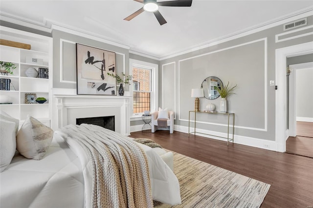 bedroom with ceiling fan, crown molding, and dark hardwood / wood-style floors