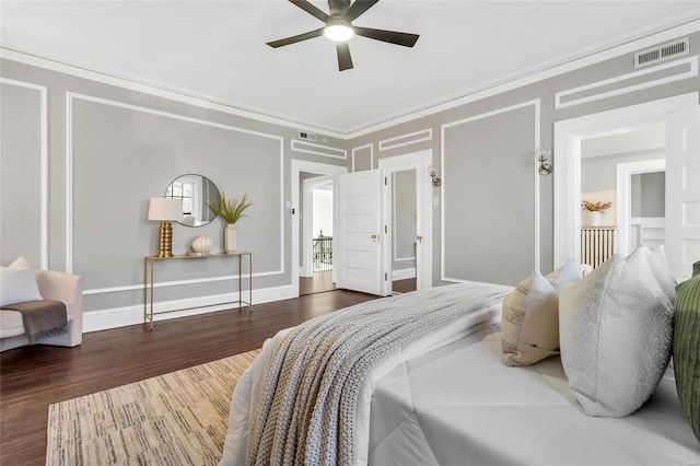 bedroom with ceiling fan, crown molding, and dark wood-type flooring