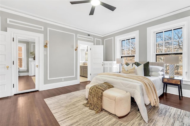 bedroom with ceiling fan, crown molding, ensuite bathroom, and dark hardwood / wood-style floors