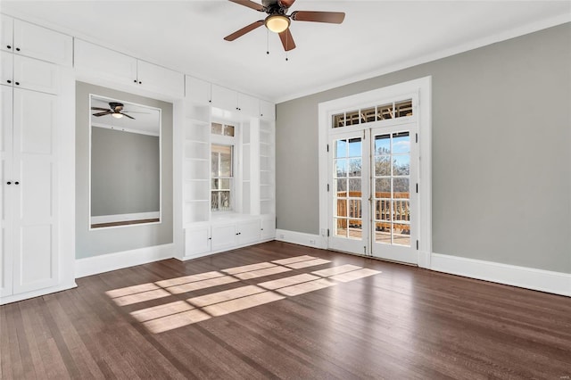 empty room featuring dark hardwood / wood-style floors, ceiling fan, and crown molding