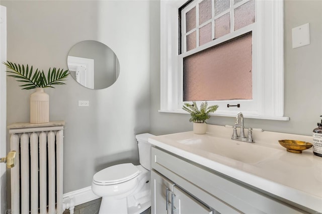 bathroom with radiator, tile patterned flooring, vanity, and toilet