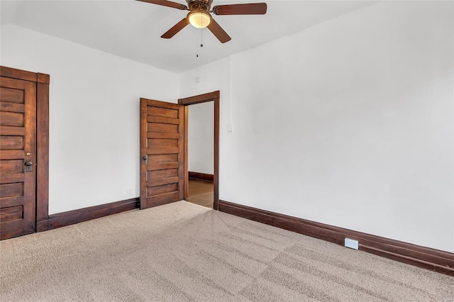 carpeted spare room with ceiling fan