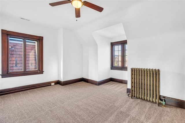 bonus room featuring carpet floors, radiator, lofted ceiling, and ceiling fan