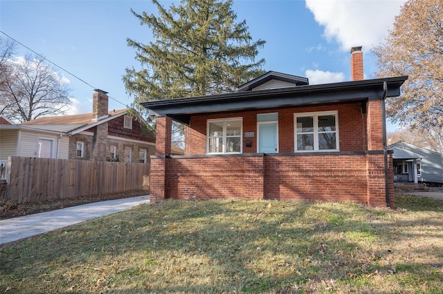 bungalow-style home with a front lawn