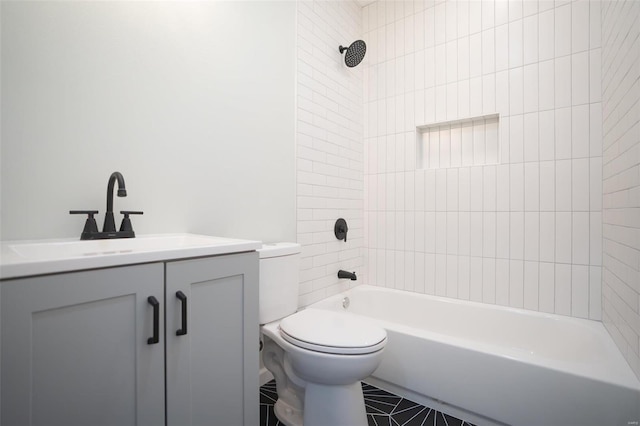 full bathroom with tile patterned flooring, vanity, toilet, and tiled shower / bath combo