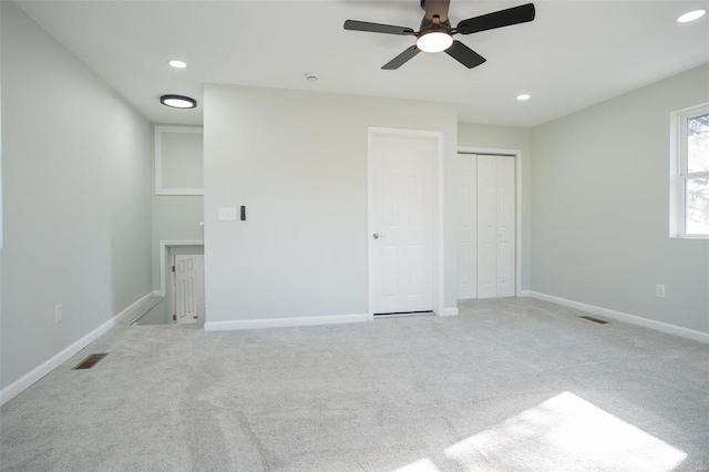 unfurnished bedroom featuring ceiling fan and light carpet