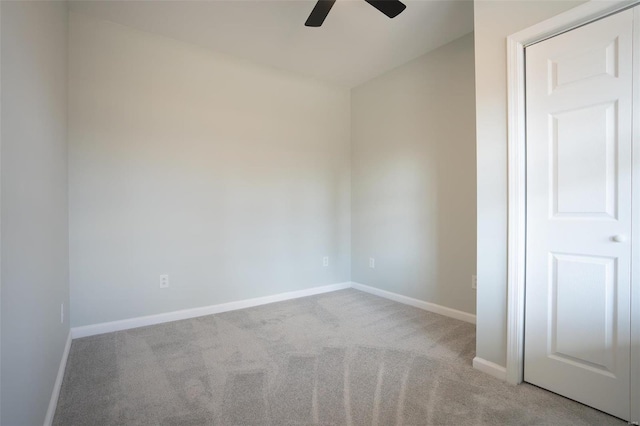 empty room featuring light carpet and ceiling fan