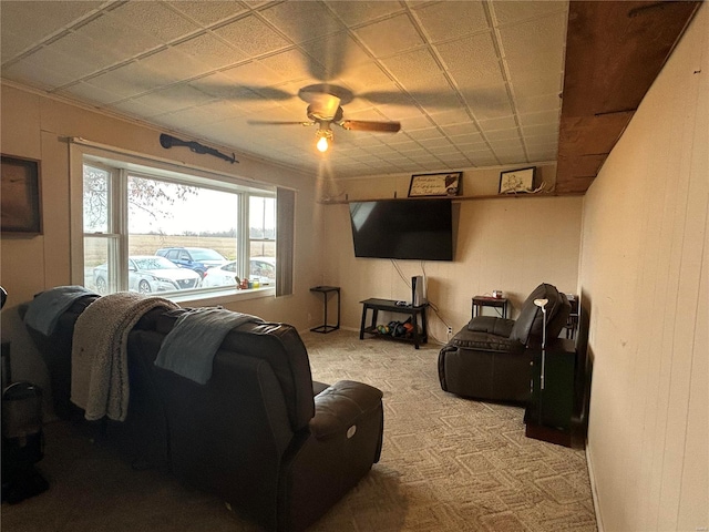 carpeted living room with ceiling fan