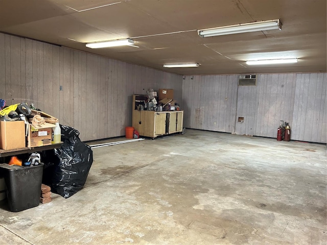 basement featuring wood walls